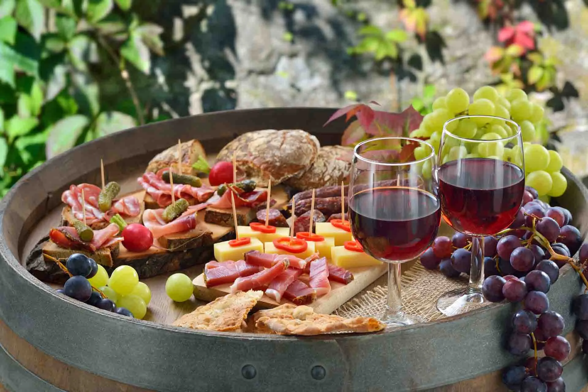 Italialaisia antipasteja viinin ja rypäleiden kera Italialaisia antipasteja viinin ja rypäleiden kera